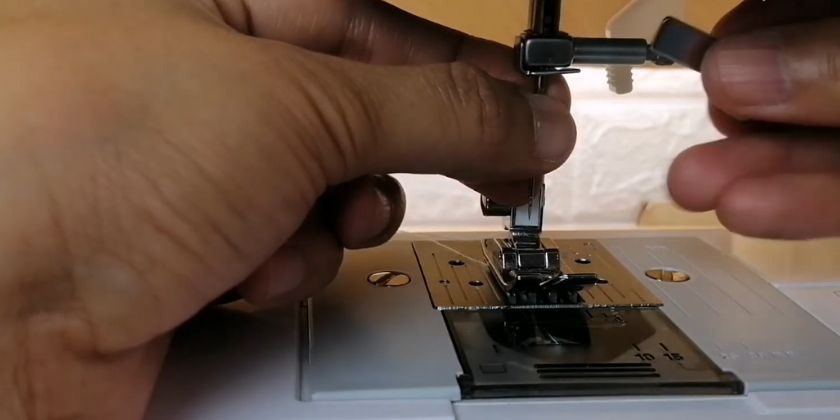 screw the needle clamp knob